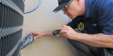 HVAC technician performing maintenance inspection