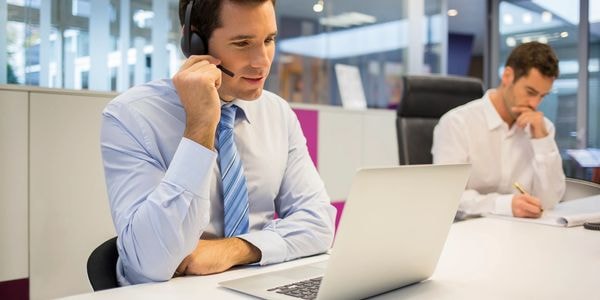 Property manager working at desk with headset
